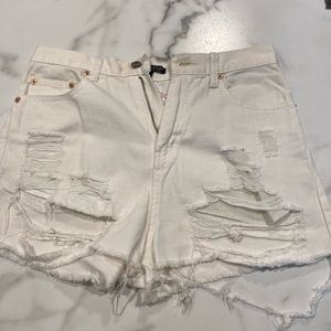 High waisted white distressed jean shorts.